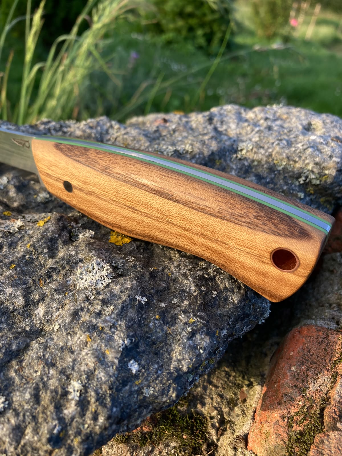 Bushcraft knife in leather sheath with dangler, front view