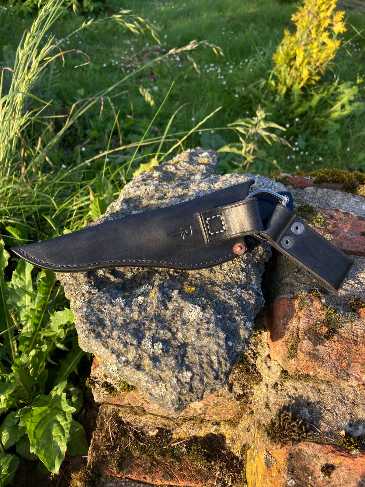 Black leather sheath with dangler on stone