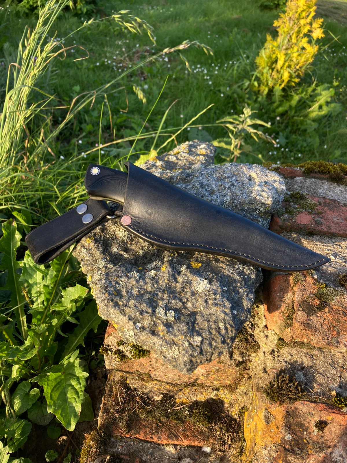 Black leather sheath back view with belt loop