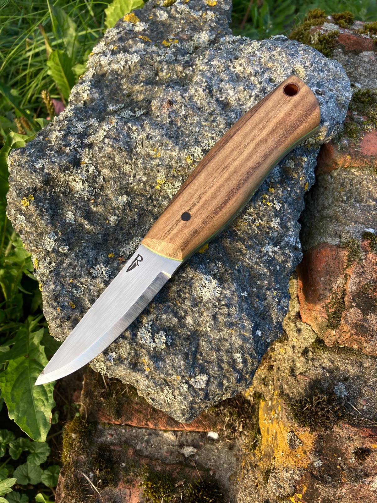 Leather sheath back view with Roland's Blades logo